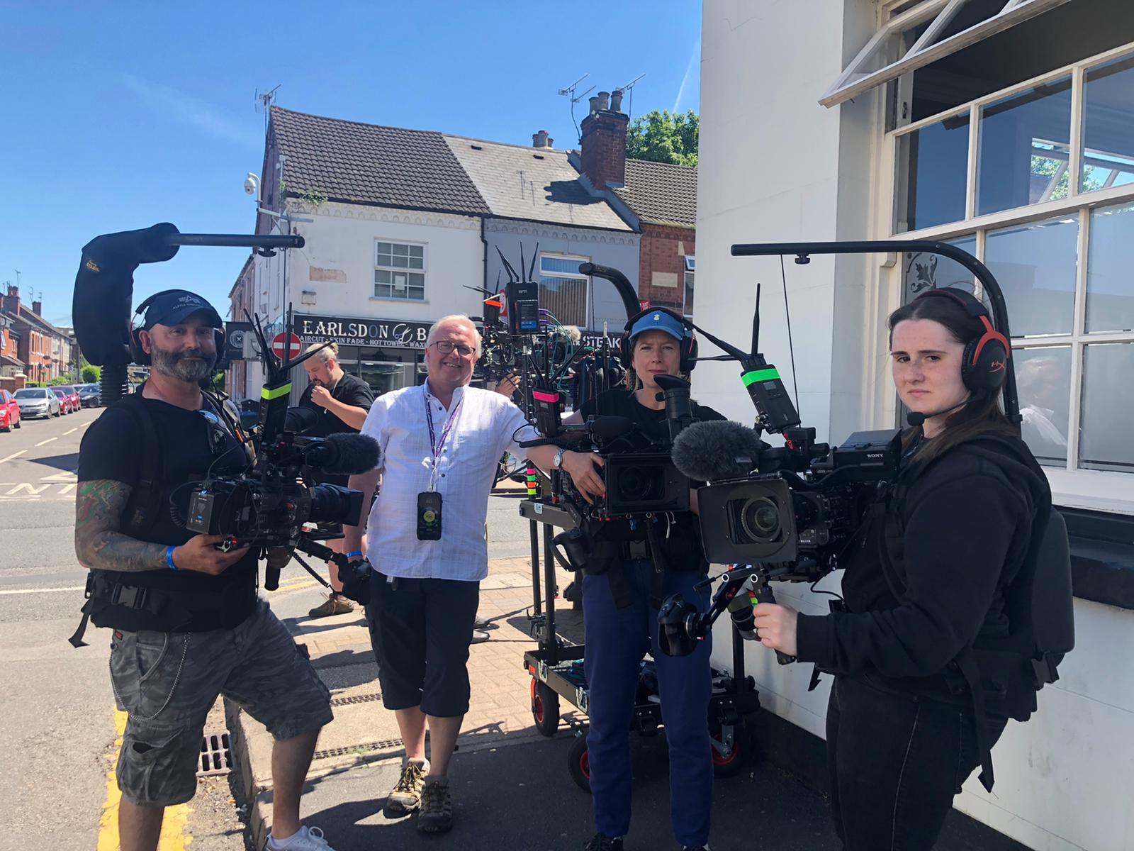 Mobile camera crew filming a Coventry Moves sequence on a Coventry street.
