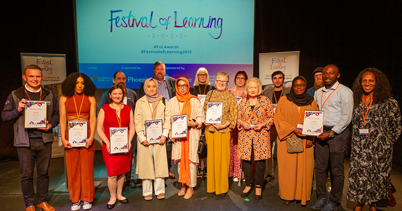 Festival of Learning 2023 award recipients celebrating together on stage