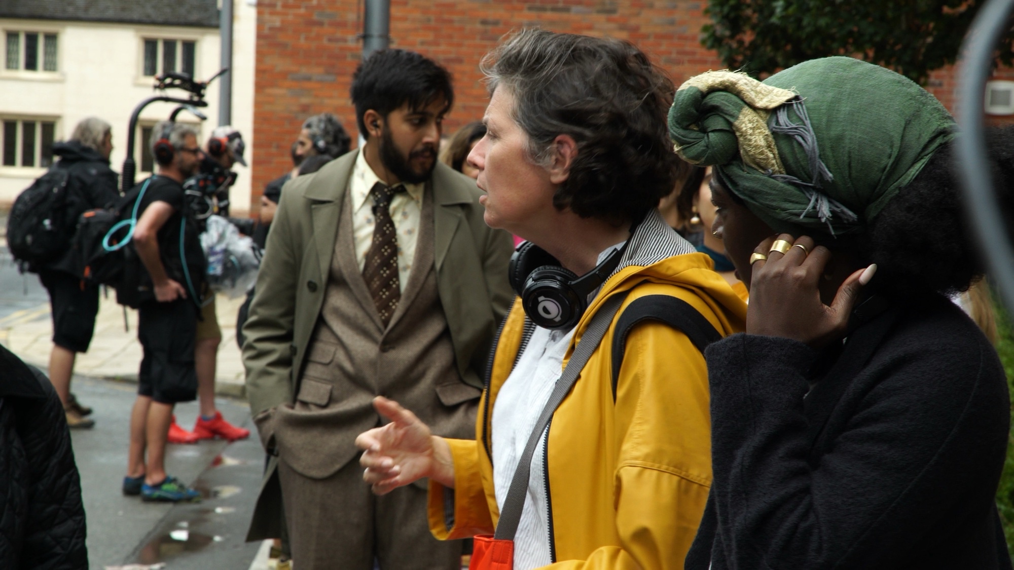 Camera and production crew following RSC Faith performers through Coventry.